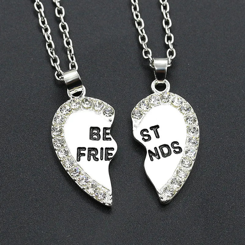 Two silver heart-shaped pendants with 'BEST FRIENDS' on a dark background