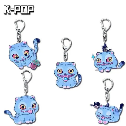 Set of blue cat-shaped keychains with a cartoon design on a white background.